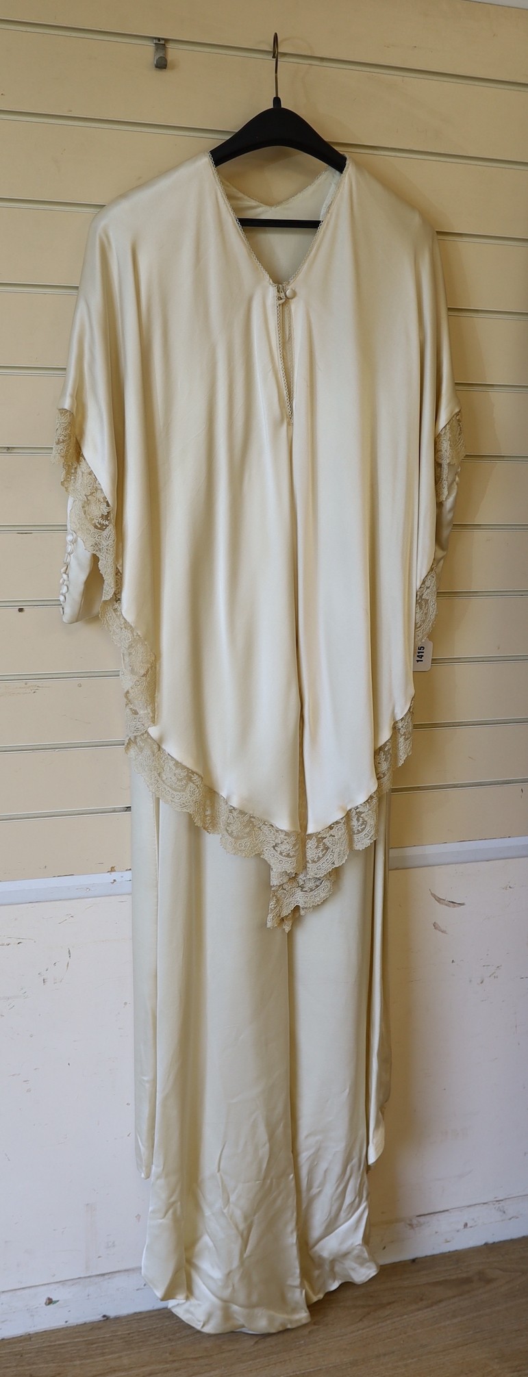 A 1970's cream satin wedding dress, trimmed with 19th century point de gaze, hand made needlepoint lace